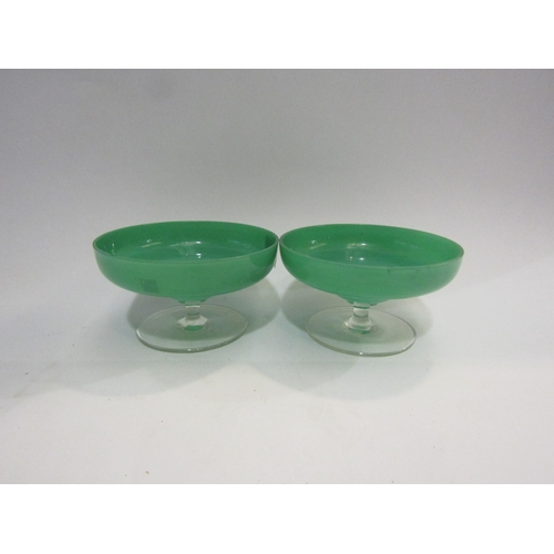 4404 - A pair of sage green glass shallow form dishes on clear stems, a/f   (C)