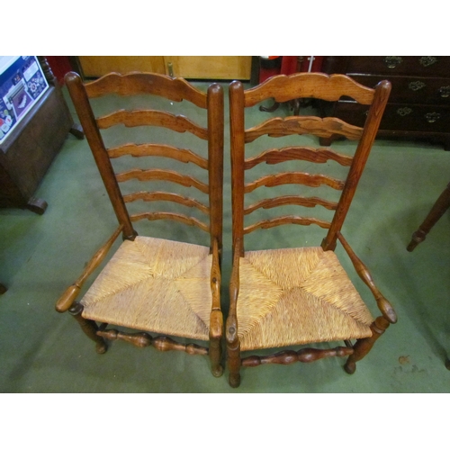 4064 - A pair of ladder-back rush seated chairs. Low seat height (35cm)   (E) £30-45