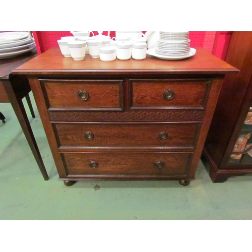 4073 - A circa 1920 oak chest of small proportions, the two short over two long drawers with blind fret dec... 