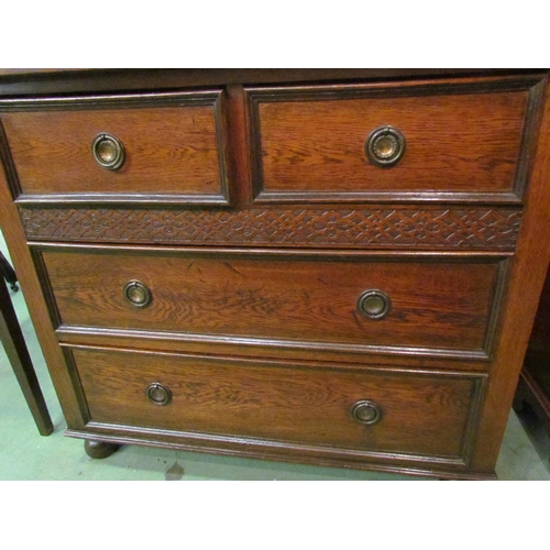 4073 - A circa 1920 oak chest of small proportions, the two short over two long drawers with blind fret dec... 