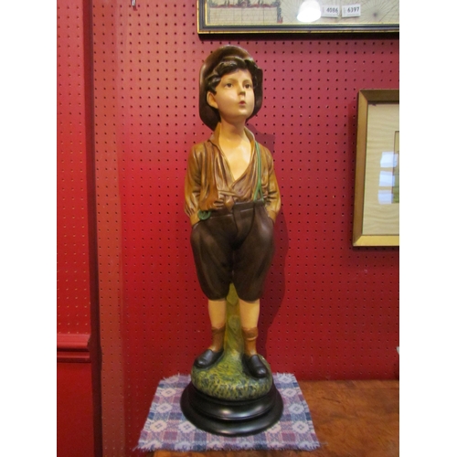 4089 - A resin chalkware figure of a boy, 65cm tall