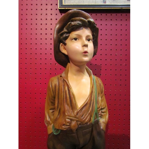 4089 - A resin chalkware figure of a boy, 65cm tall