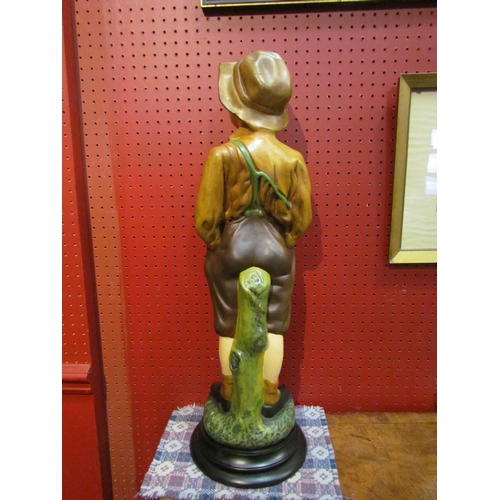 4089 - A resin chalkware figure of a boy, 65cm tall