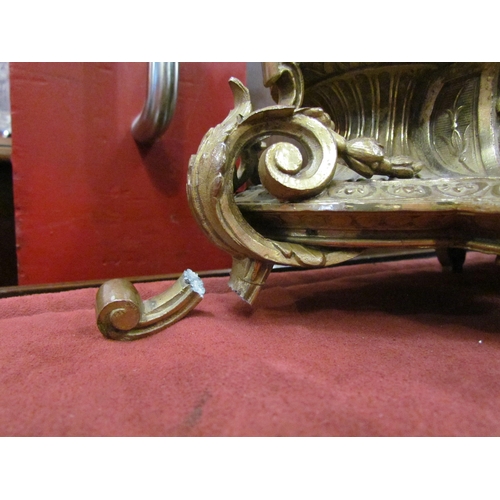 4092 - A gilt mantel clock surmounted by a 16th Century artist, one leg a/f, with key and pendulum