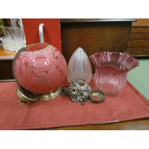 4093 - Three glass lamp shades, spherical cranberry coloured embossed example, cranberry etched oil lamp sh... 