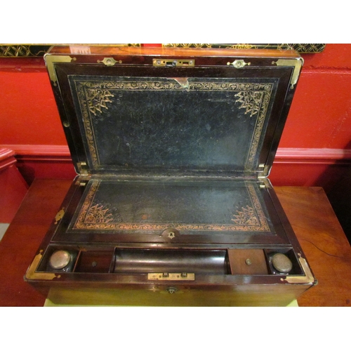 4113 - A mahogany writing slope, brass cartouche, escutcheon, military handles, secret drawer, split to top... 