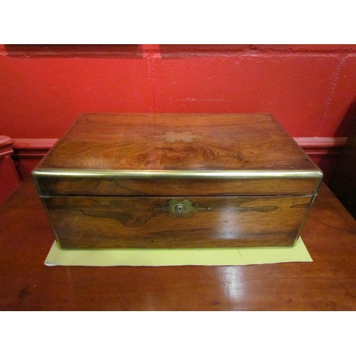 4113 - A mahogany writing slope, brass cartouche, escutcheon, military handles, secret drawer, split to top... 