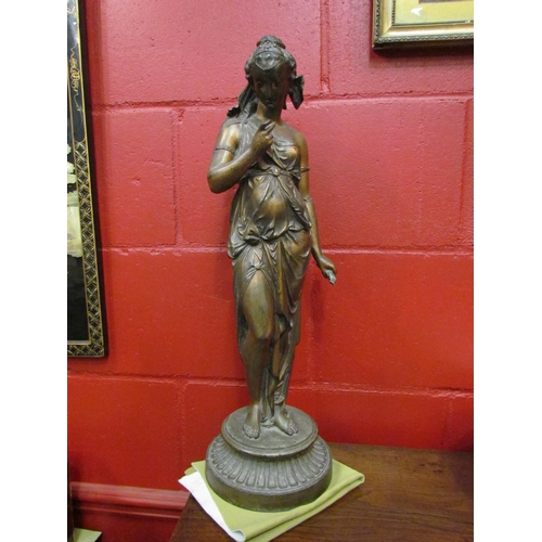 4116 - A bronzed spelter figure of a female in drapery holding arrows, 58cm tall