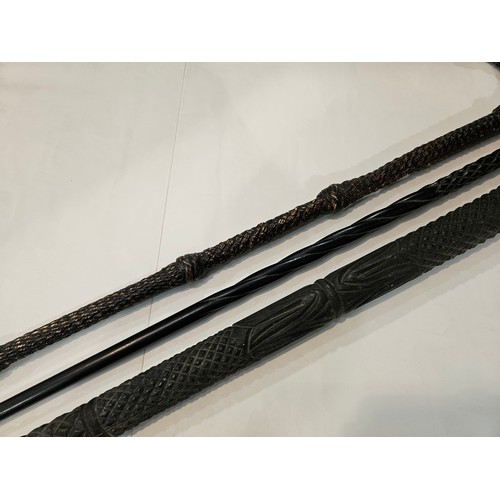 4012 - A heavy carved ebony walking stick (missing pommel and tip), slender ebony walking cane and another ... 