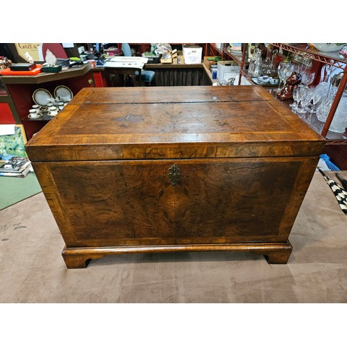 4013 - A George II style herringbone crossbanded burr walnut chest, the hinged lid over carrying handles on... 