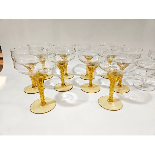 4098 - Ten champagne saucers with amber stems and four clear glass saucers