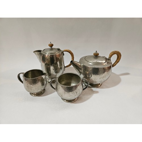 4100 - A Tudric Pewterware for Liberty & Co coffee/water pot, a Tudric teapot, milk jug and sugar bowl with... 