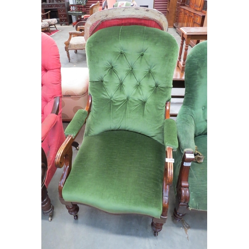 2400 - A green upholstered button back armchair on castors