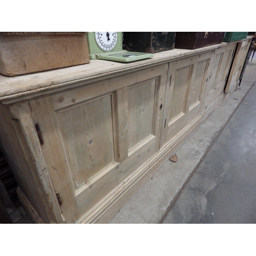 2020 - A Victorian pine four door cupboard base in two sections 311cm long x 77t x 47cm deep