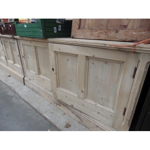 2020 - A Victorian pine four door cupboard base in two sections 311cm long x 77t x 47cm deep