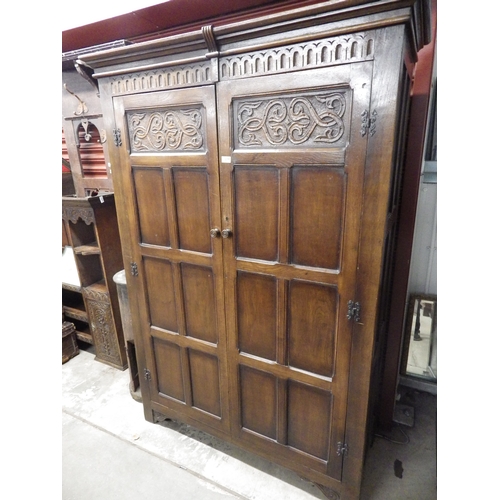 2096 - A carved oak two door wardrobe  (E)  £30-50