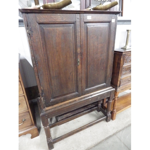 2120 - A small Georgian later oak country house cupboard on stand