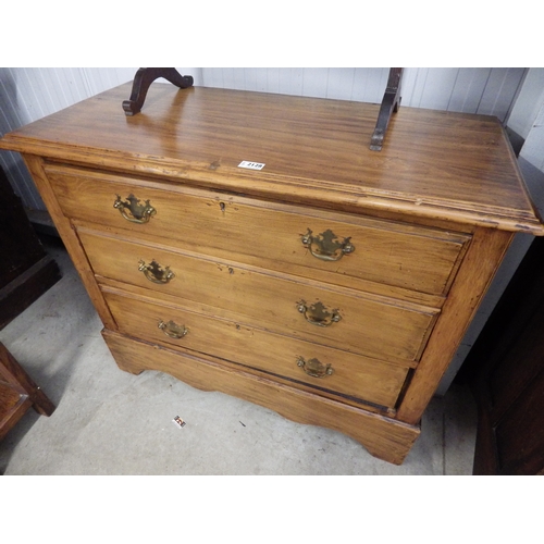 2128 - An Edwardian stripped walnut chest of three drawers