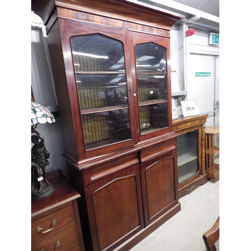 2141 - An early Victorian mahogany glazed top bookcase on cupboard with two cushion drawers   (R)  £150