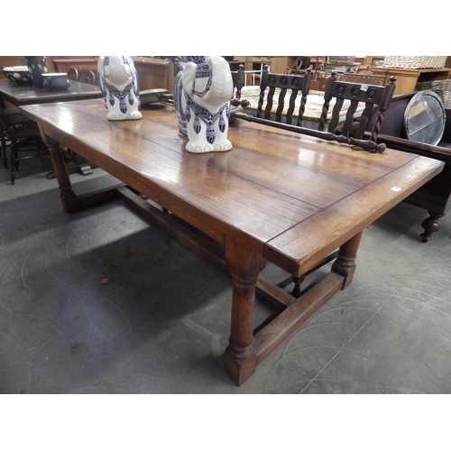 2196 - An oak refrectory dining table on gun barrell legs 102 x 244cm