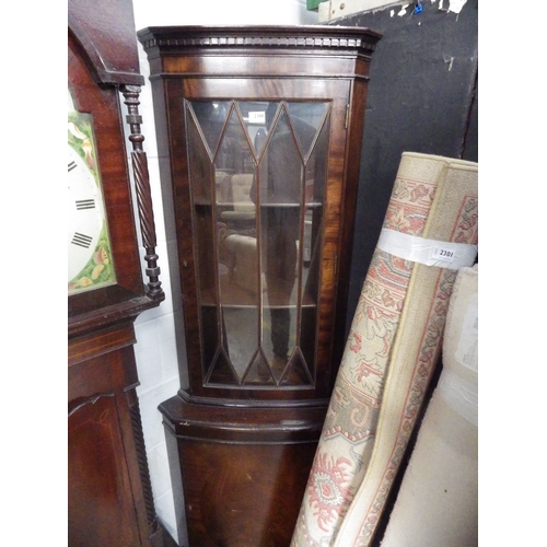 2300 - A mahogany glazed corner cabinet