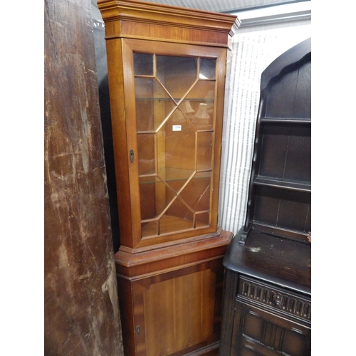 2304 - A yew wood glazed corner cabinet