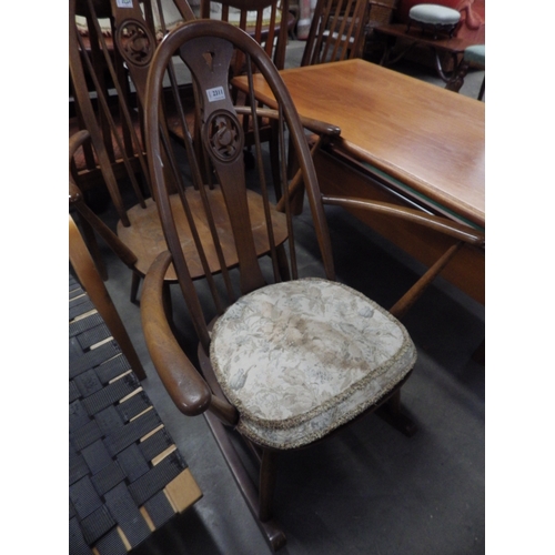 2311 - An Ercol rocking armchair with swan to splat