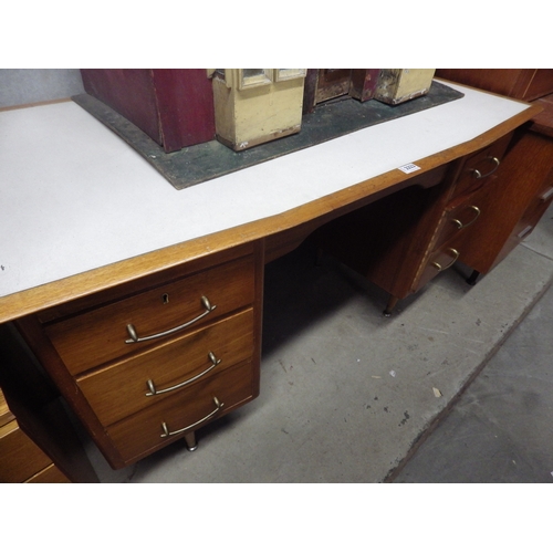 2323 - A teak six drawer desk (R)  £10