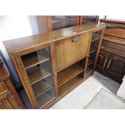 2344 - An oak side unit with bevelled edged glass doors and a shelved interior   (E)  £15-25