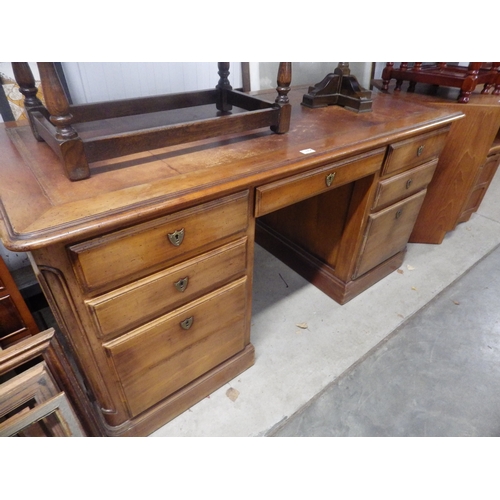 2354 - A pine seven drawer desk with slide out panels and a leather insert top, also with keys and brass sh... 