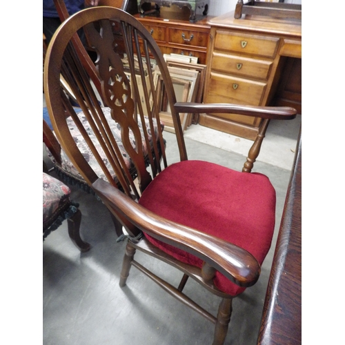 2362 - An oak table and five (4+1) wheel and stick back chairs