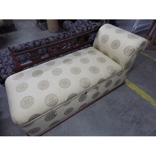 2390 - A cream Ottoman day bed on brass castors with lift up storage compartment