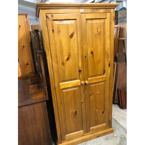 2408 - A modern pine two door wardrobe