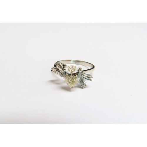 9137 - A Deco diamond ring with central pear shaped diamond 1.75ct approx with baguette cut diamond shoulde... 