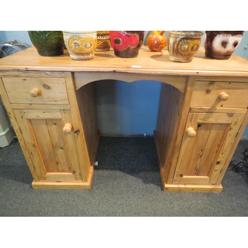 1072 - A natural pine twin pedestal desk, 79cm tall x 127cm wide x 63cm deep