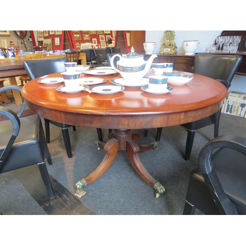 1096 - A Victorian mahogany breakfast table, round top over a reeded quatreform base with lion paw castors,... 