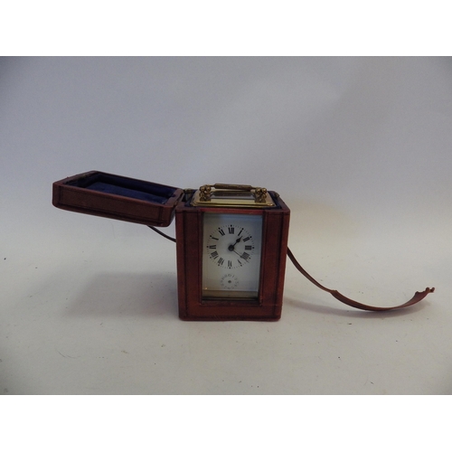 1293 - An early 20th Century French brass carriage clock in original carry case with key.  Face with crack,... 