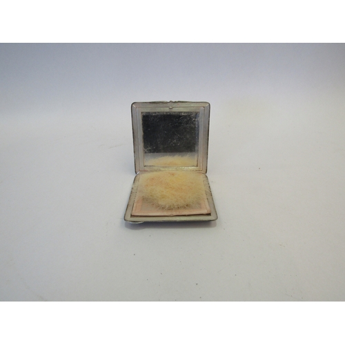 1316 - A square Continental silver compact with 18ct gold highlights, the outside with textured matt effect... 