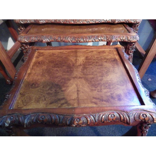 1008 - A carved mahogany nest of three occasional tables, missing one glass top