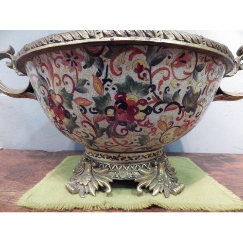 1036 - A large gilt metal mounted twin handled ceramic bowl with floral design, 21cm tall x 55cm wide