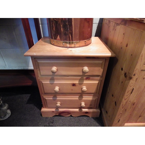 1075 - A pine three drawer bedside cabinet, 50cm tall x 51cm wide x 38cm deep