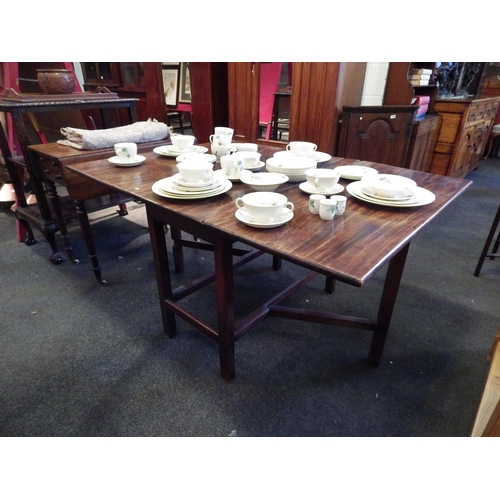 1139 - A stained oak gate-leg dining table, 70cm tall x 134cm long x 99cm wide