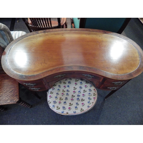 1152 - A mahogany veneer kidney shaped dressing table and stool, some fading to top