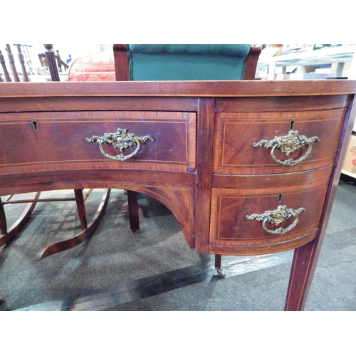 1152 - A mahogany veneer kidney shaped dressing table and stool, some fading to top