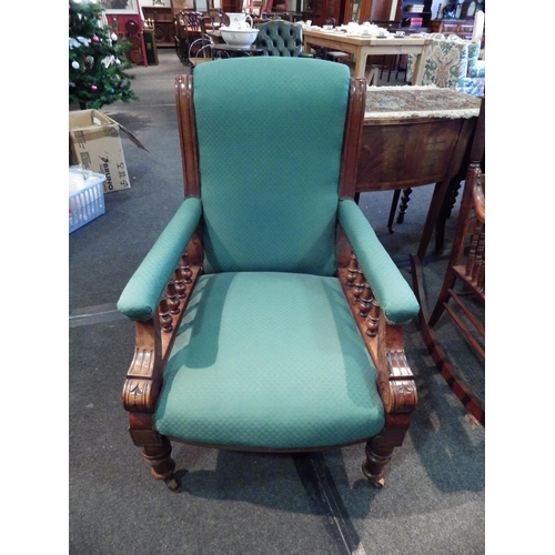 1154 - A 19th Century armchair, mahogany framed, spindle detail, turned front legs raised on porcelain cast... 