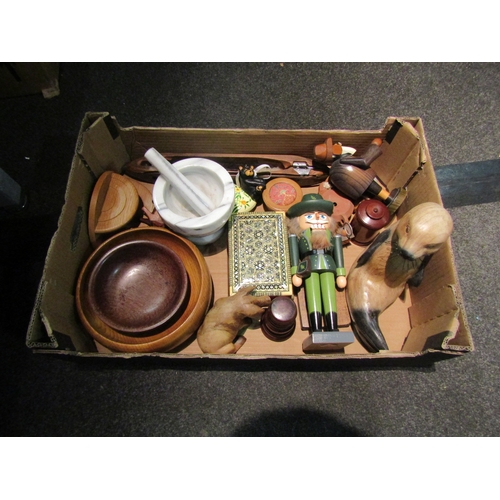 1160 - A box of mostly treen ware including bowls, German nutcracker, carved animals etc.