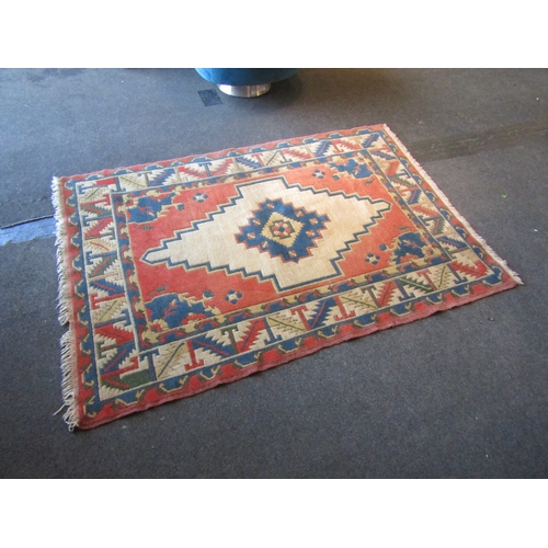 1480 - A cream, terracotta and blue ground geometric design rug, central lozenge with multiple borders and ... 