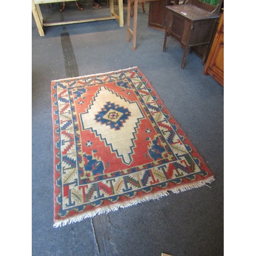 1480 - A cream, terracotta and blue ground geometric design rug, central lozenge with multiple borders and ... 