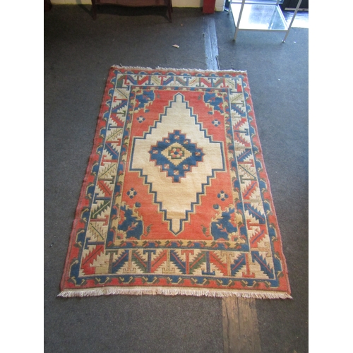 1480 - A cream, terracotta and blue ground geometric design rug, central lozenge with multiple borders and ... 