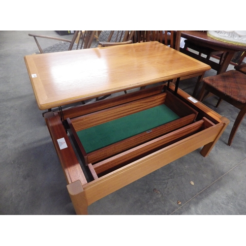 2387 - A Nathan teak coffee table with a smooth lift top motion revealing a fitted interior